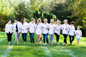 A group of bridesmaids (plus flower girl) in white shirts, looking elegant and ready to support the bride (in the middle) on her special day. #WeddingVibes