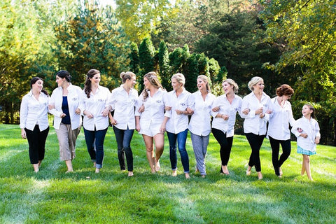 A group of bridesmaids (plus flower girl) in white shirts, looking elegant and ready to support the bride (in the middle) on her special day. #WeddingVibes
