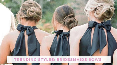 Trending styles: bridesmaids bows, image shows three bridesmaids from the back in black dresses with halter top bows