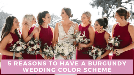 Bride wearing white dress surrounded by six bridesmaids wearing burgundy dresses