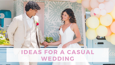 A smiling bride in a white dress and groom in a cream suit hold hands at a casual wedding, beside pastel balloons and a banner reading “Ideas for a Casual Wedding.”