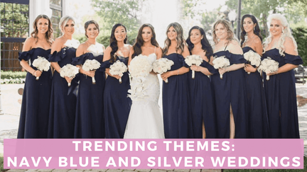 Bride wearing silver dress and bridesmaids wearing navy blue dresses