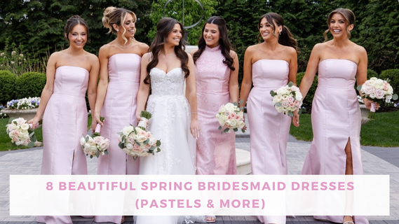 A smiling bride in a white gown stands with five bridesmaids in pastel pink dresses, holding bouquets in a garden—a cheerful spring wedding scene.