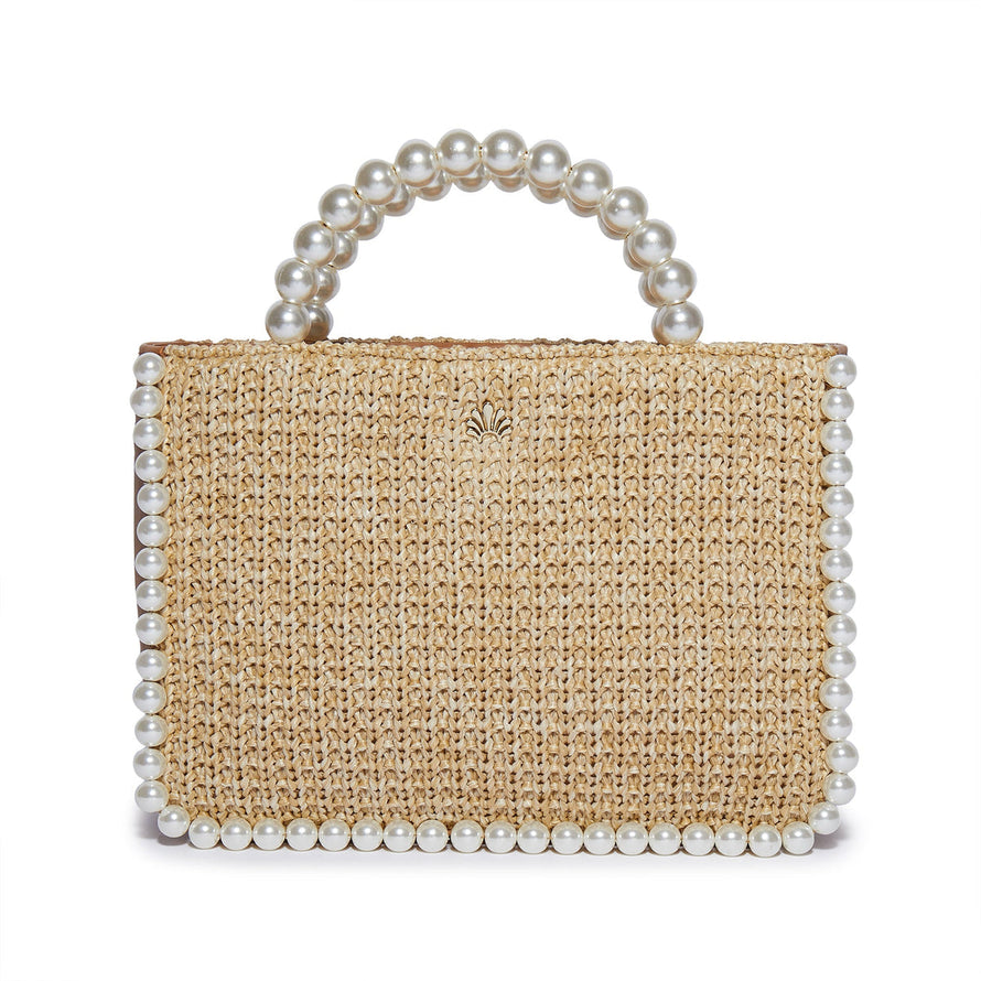 The beige Maya mini tote with genuine leather side and base panels and natural woven raffia front and back panels features a hand-beaded edge adorned with faux pearls and a faux pearl beaded top handle.