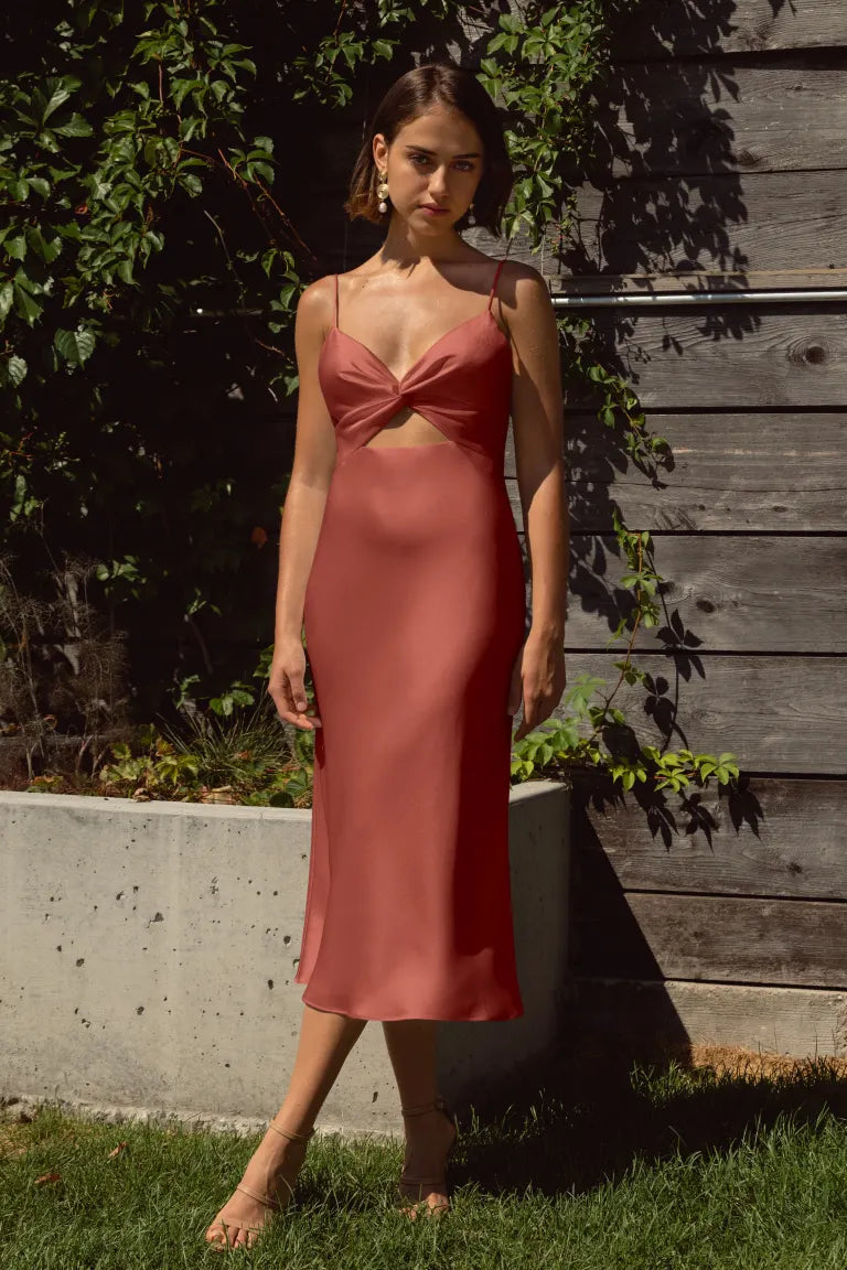 With its elegantly twisted bodice, alluring cutout detail, and a gracefully draped bias-cut skirt, this contemporary slip dress is destined to captivate attention!