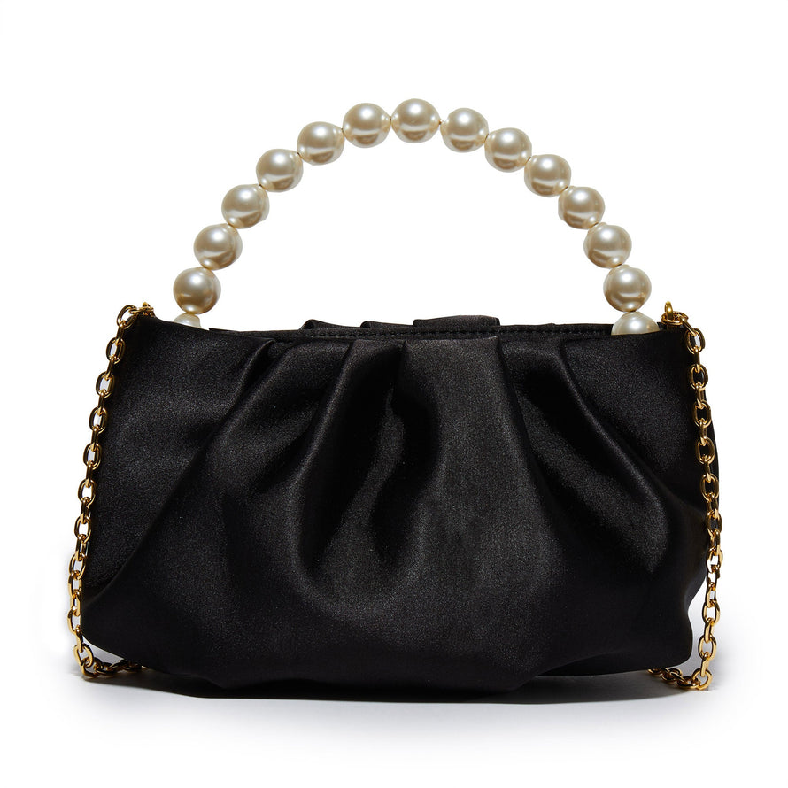 This pouch is constructed from jet ruched poly blend satin, adorned with a faux pearl top handle, secured with a magnetic closure and equipped with a hidden 14k gold plated chain shoulder strap measuring 45".